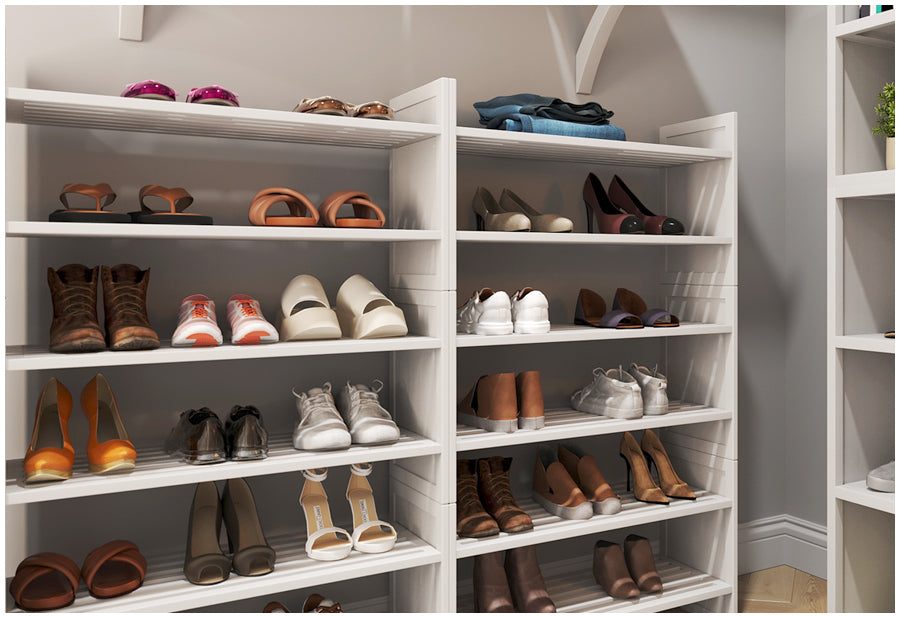 two 3 tiered shoe racks used in a custom walk in closet neatly organizing shoes and more